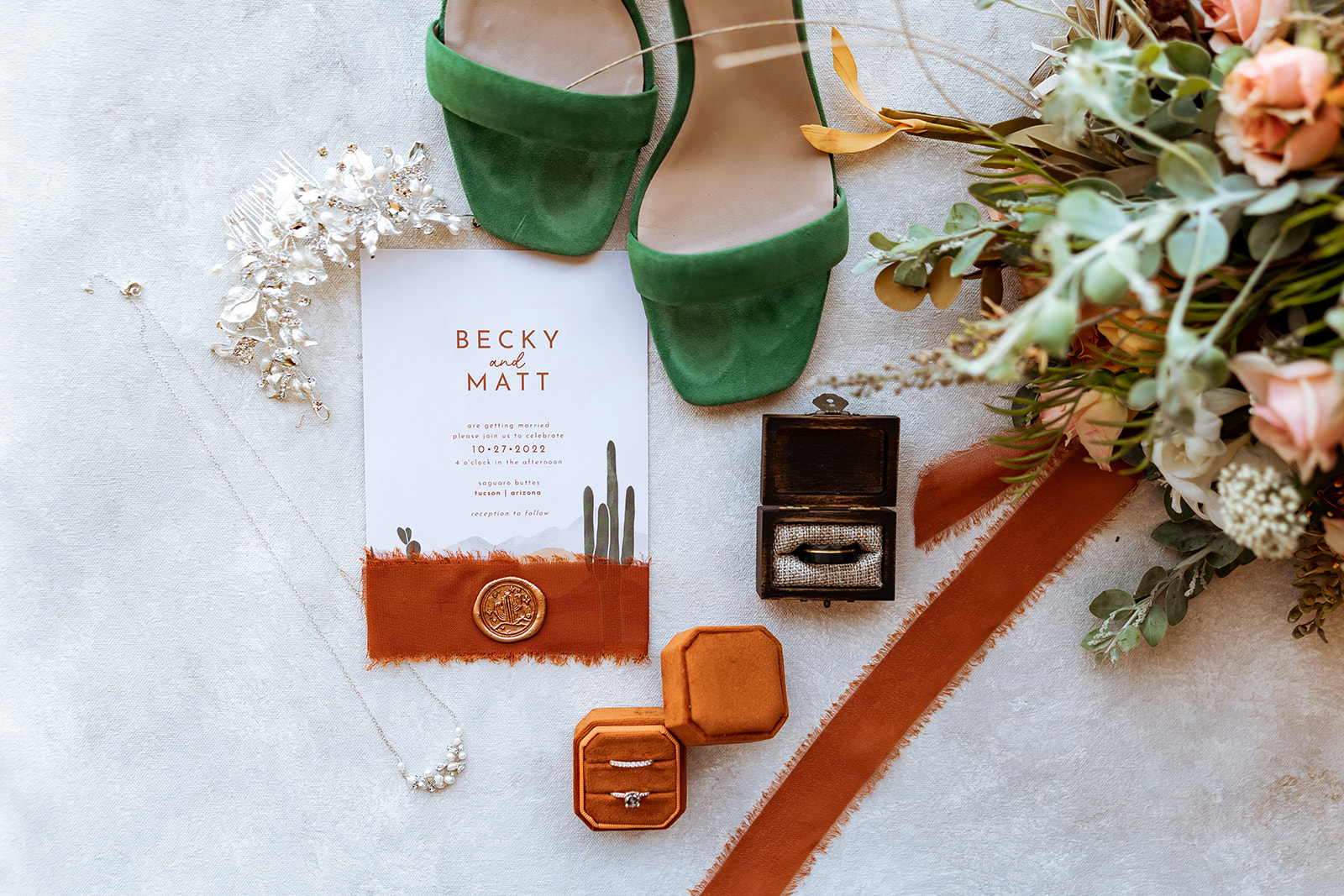 details for desert wedding including ring, shoes, and invitation