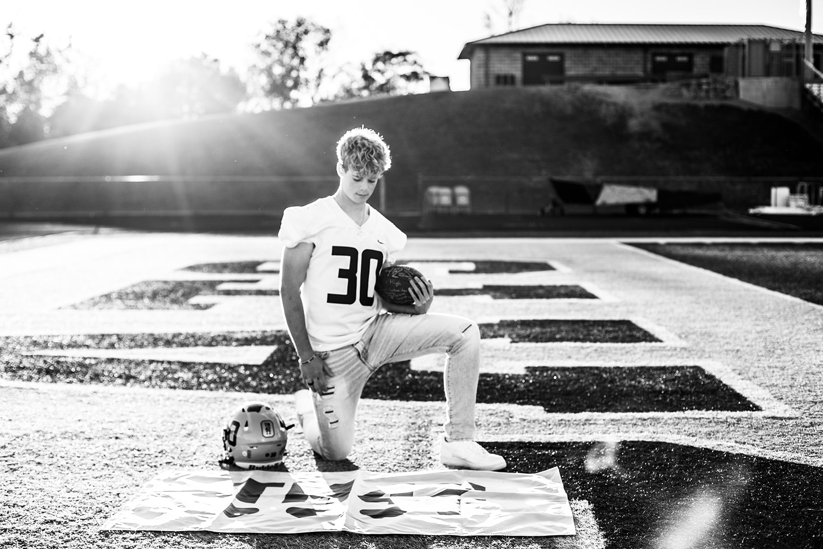 Logan on the field of the Oxford High School stadium during his senior session