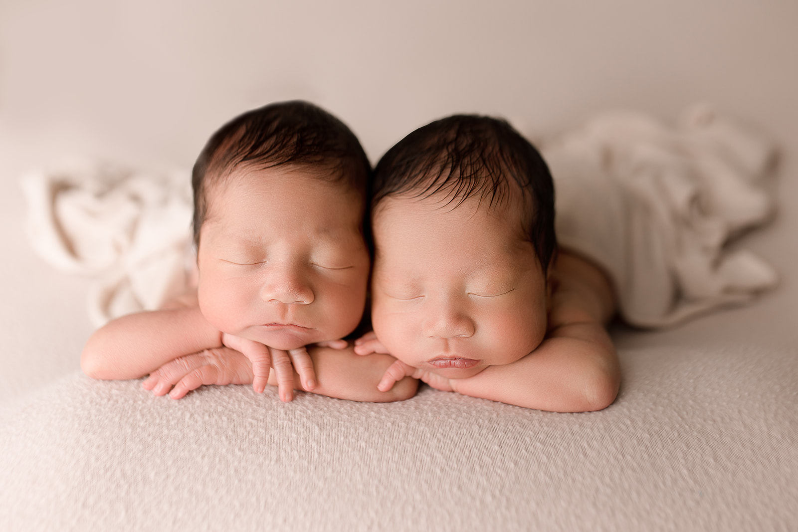 identical newborn twins side by side