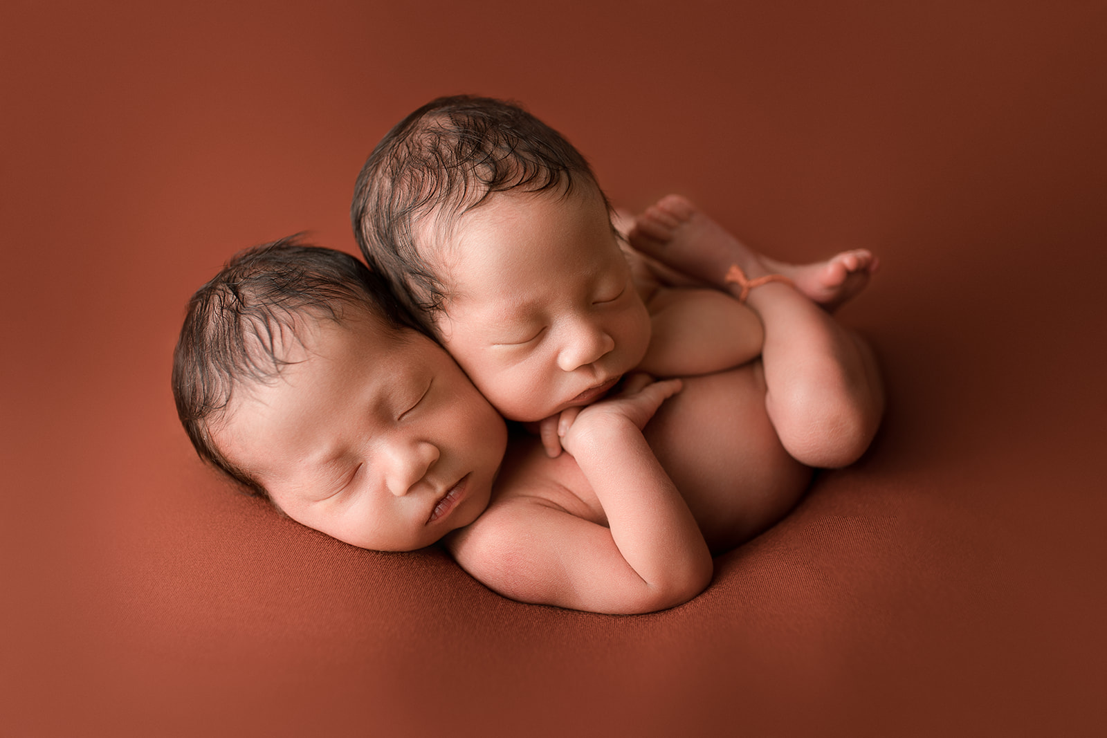 identical twins on copper color backdrop