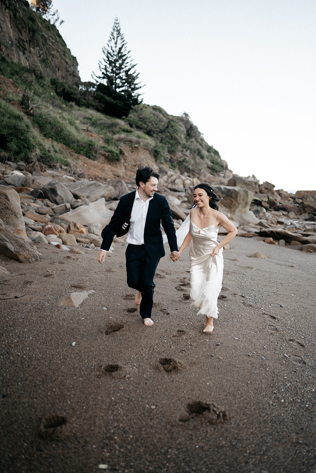 Couple running on Coalcliff Beach