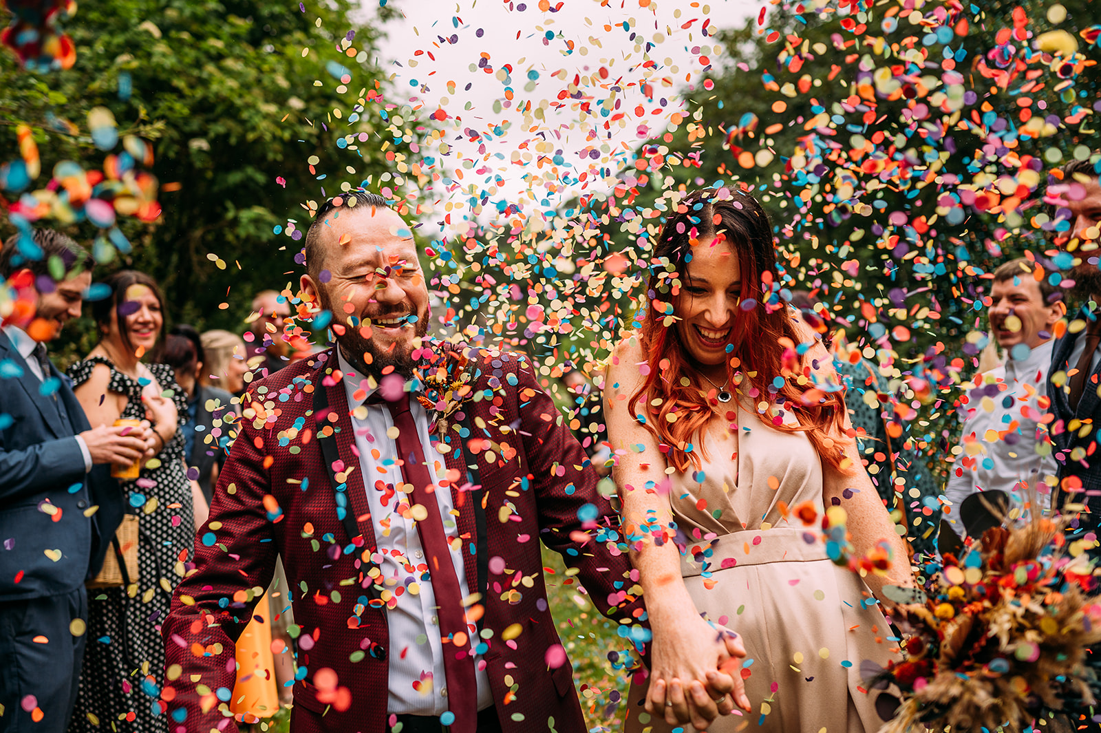 Couple walk through loads of confetti