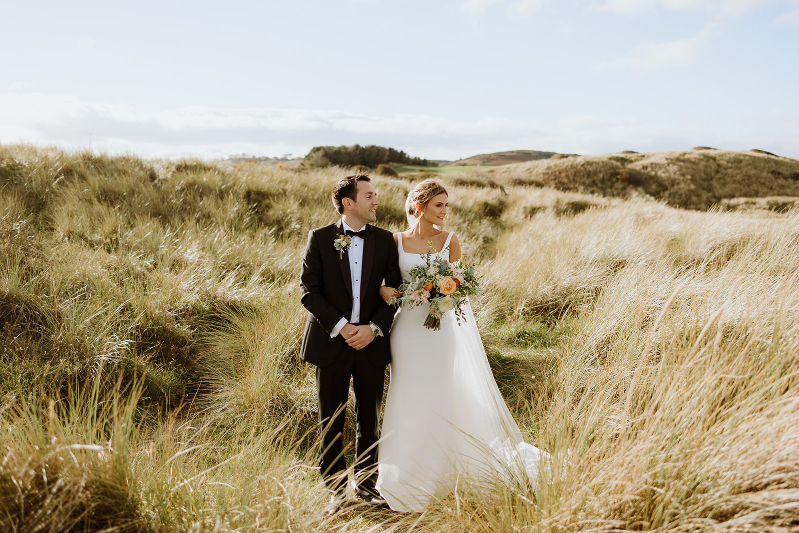 Wedding photographs on Bamburgh beach, black tie autumn wedding