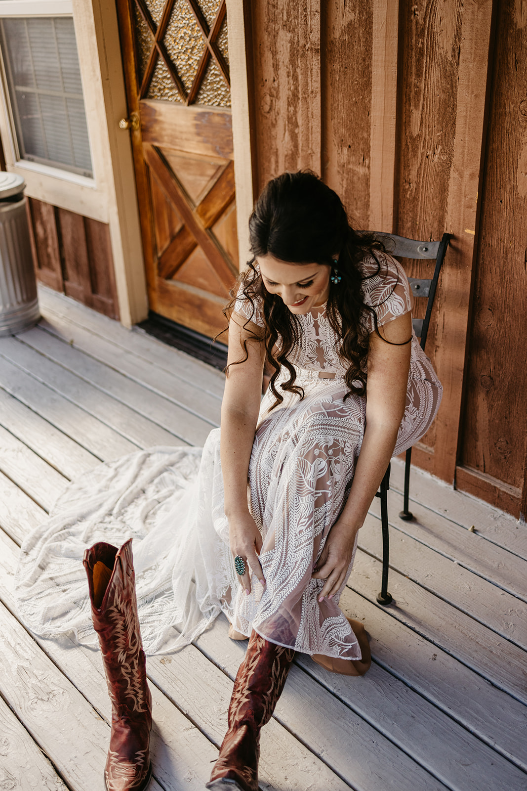 Bride putting on red cowboy boots