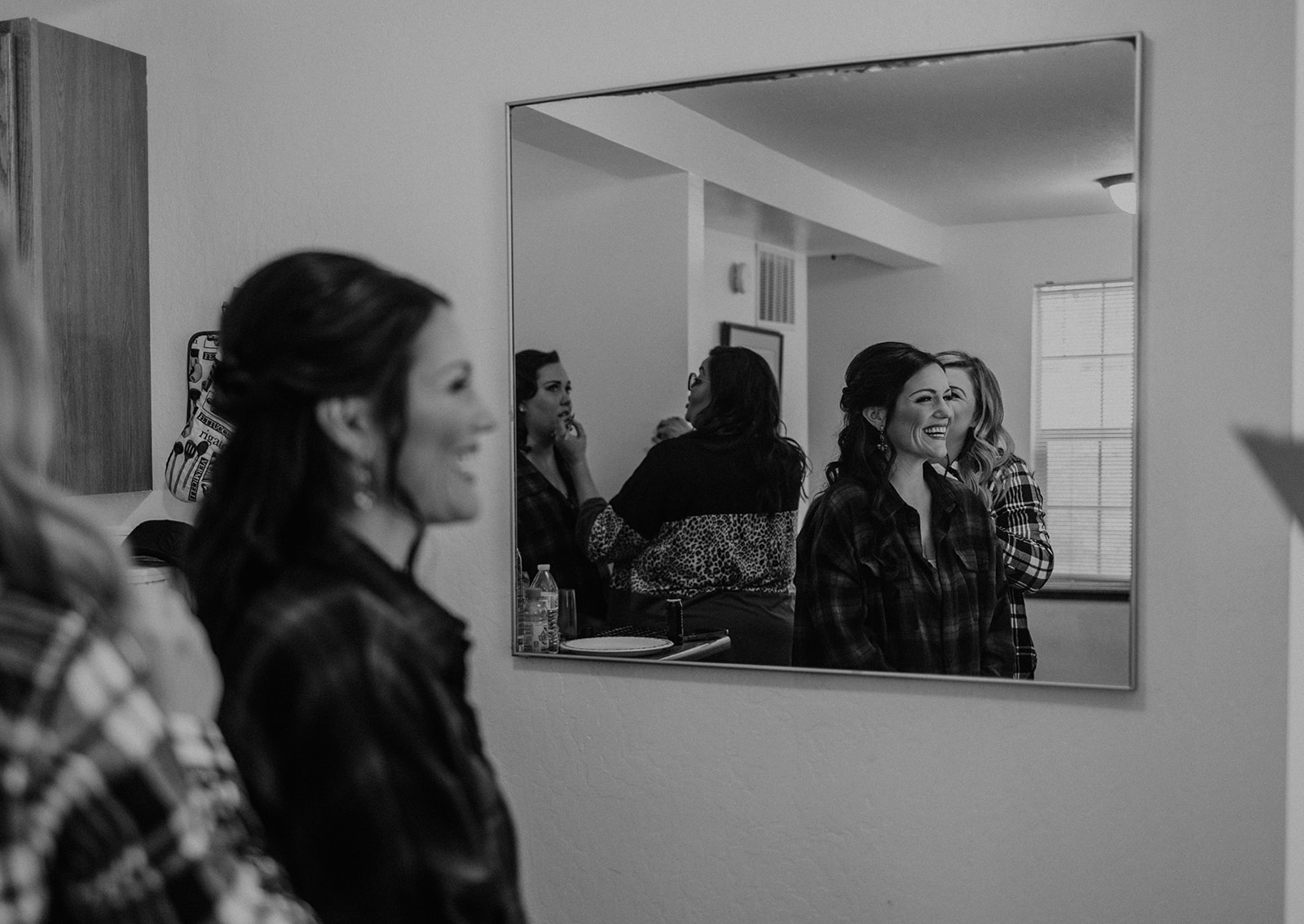 Black and white photo of a bride getting ready on her wedding day 