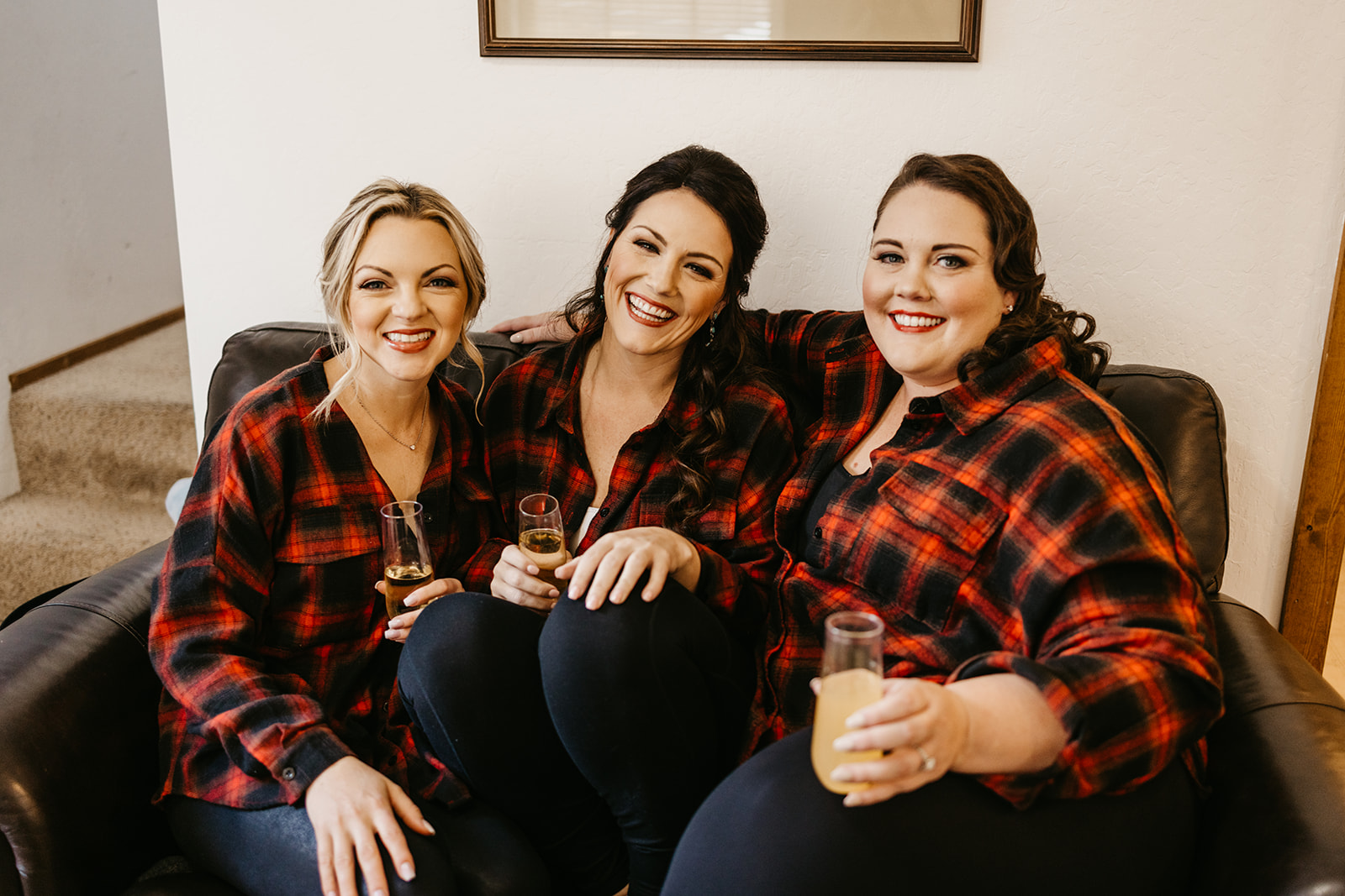 Bride and bridesmaids sitting on a couch