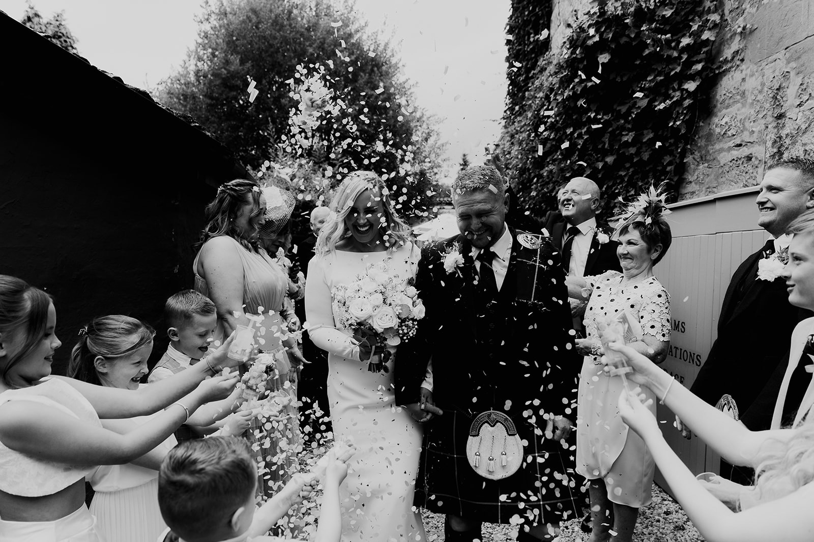 Wedding Couple getting covered in confetti