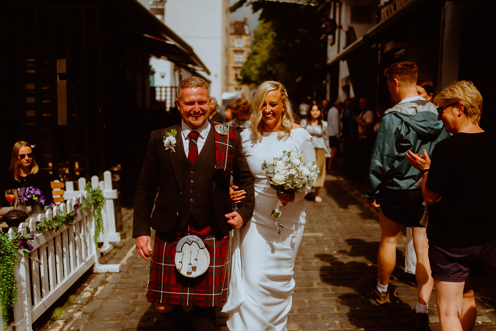 Wedding couple walking through Ashton Lane, Glasgow.