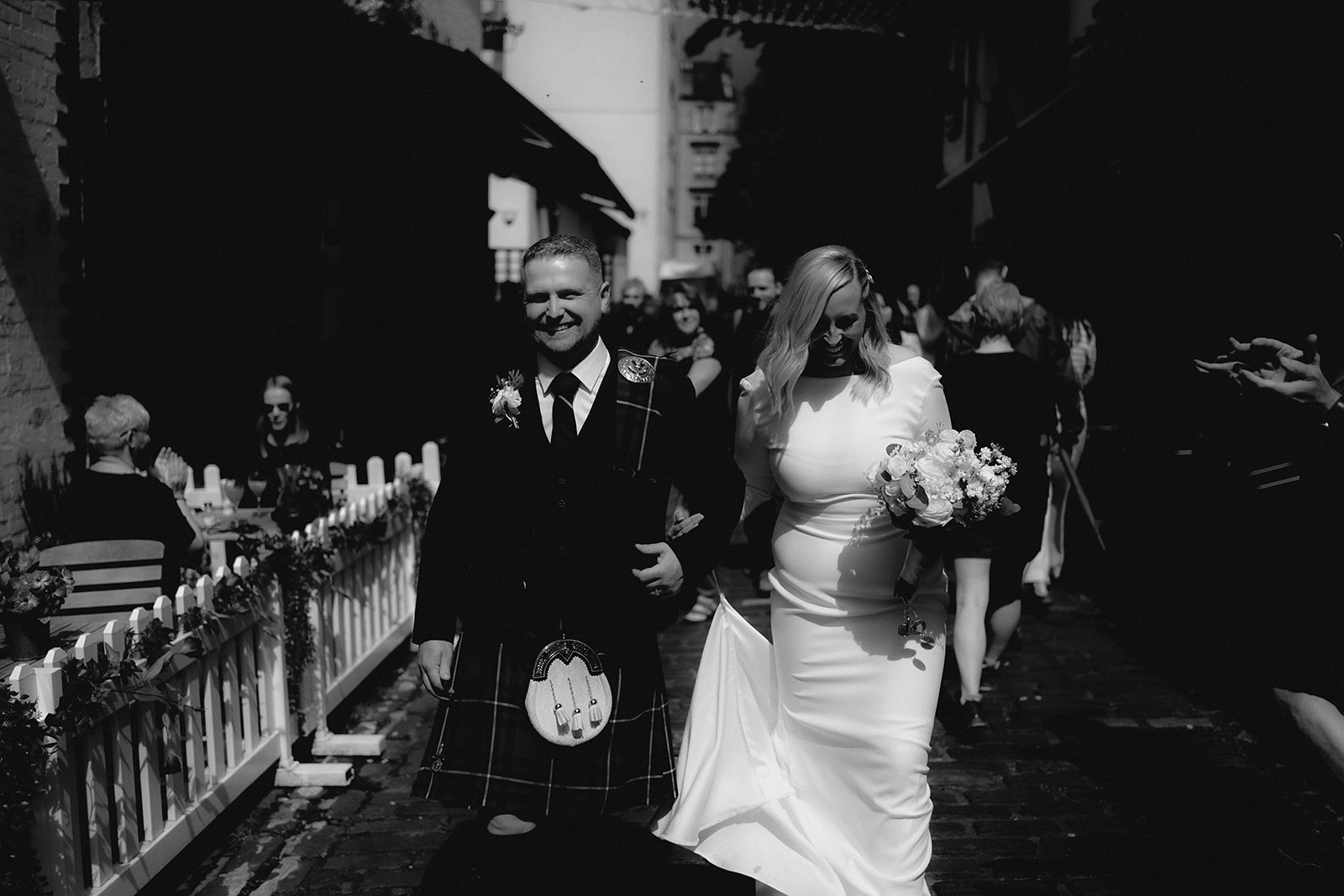 Wedding couple walking through Ashton Lane, Glasgow.