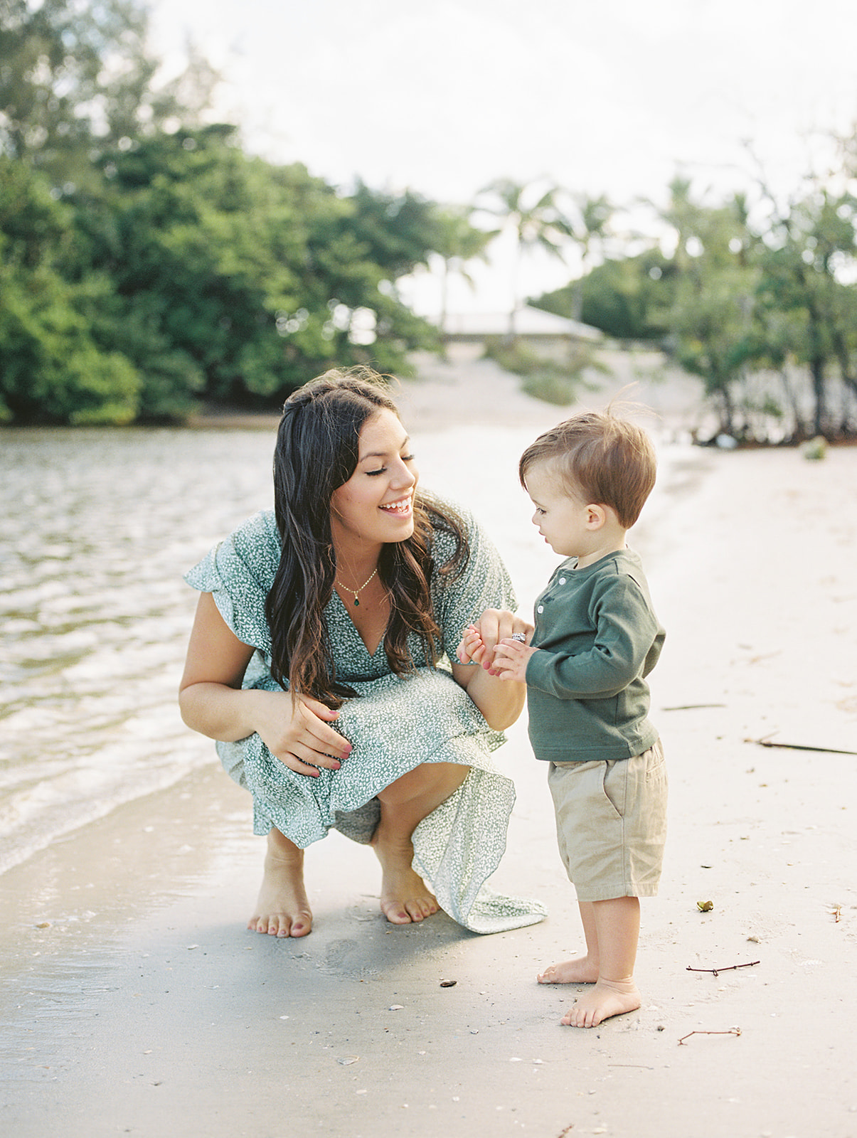 mom shows son a shell during west palm beach family photo session