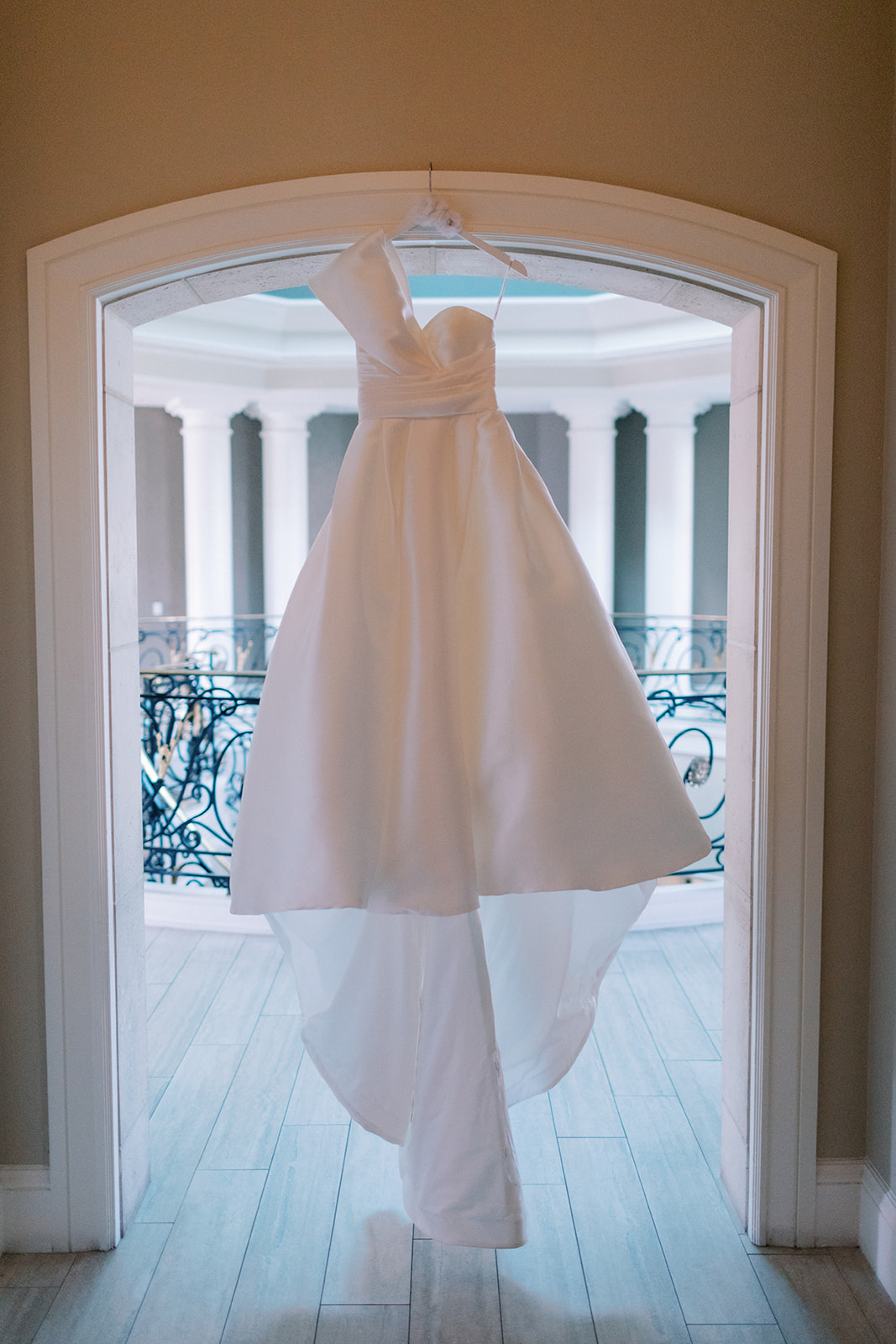 detail shot of a wedding dress hanging in a window