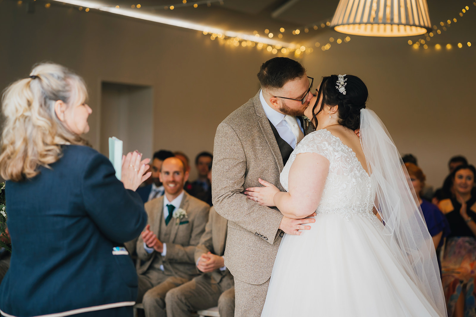 bride and groom share their first kiss and a married couple