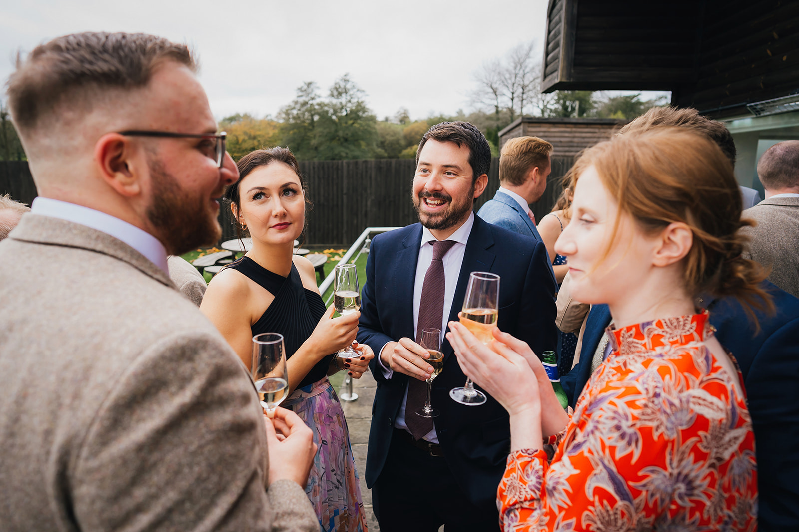 wedding guests drinking champagne and eating canapés