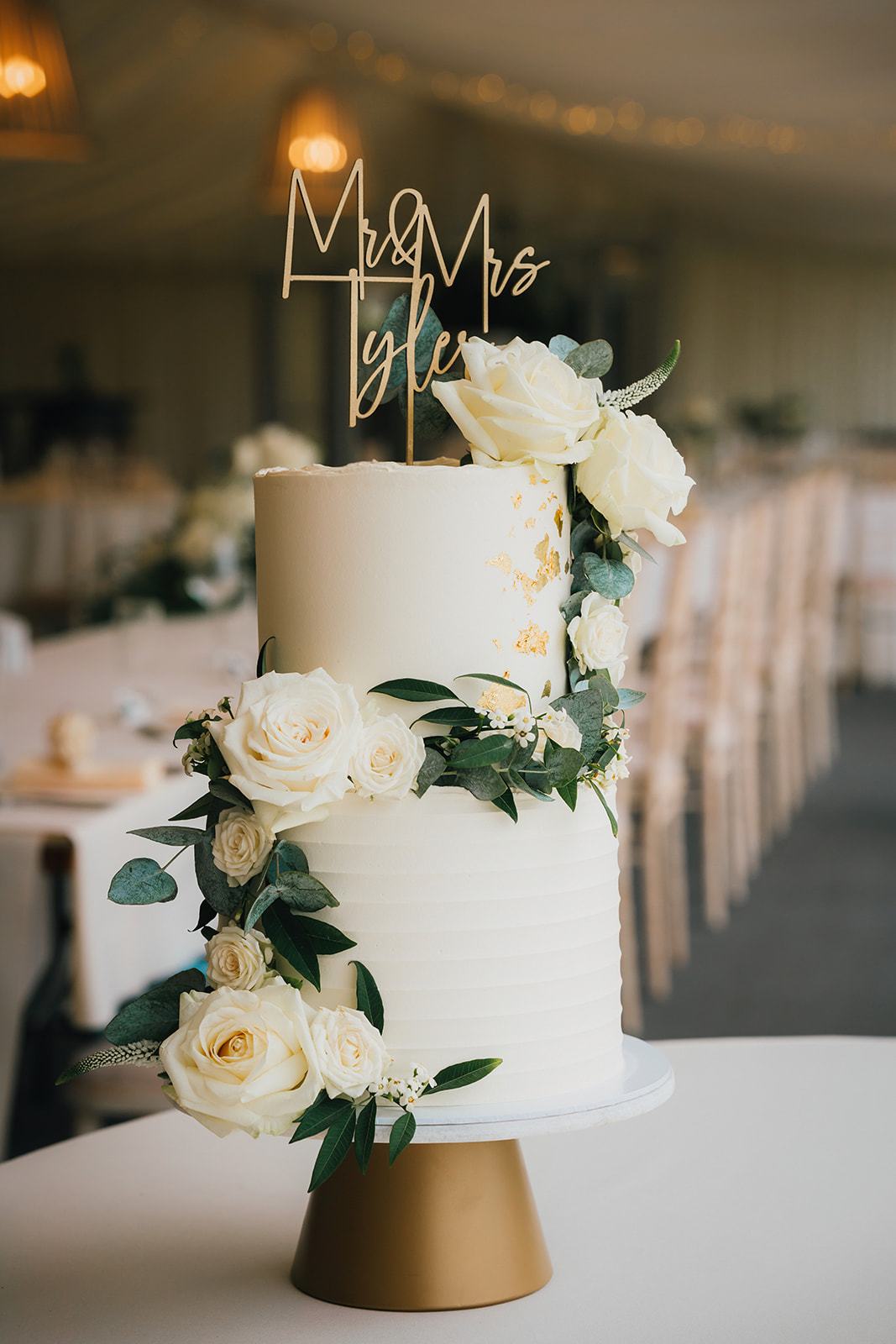 W three tiered wedding cake with a Mr and Mrs sign on the top