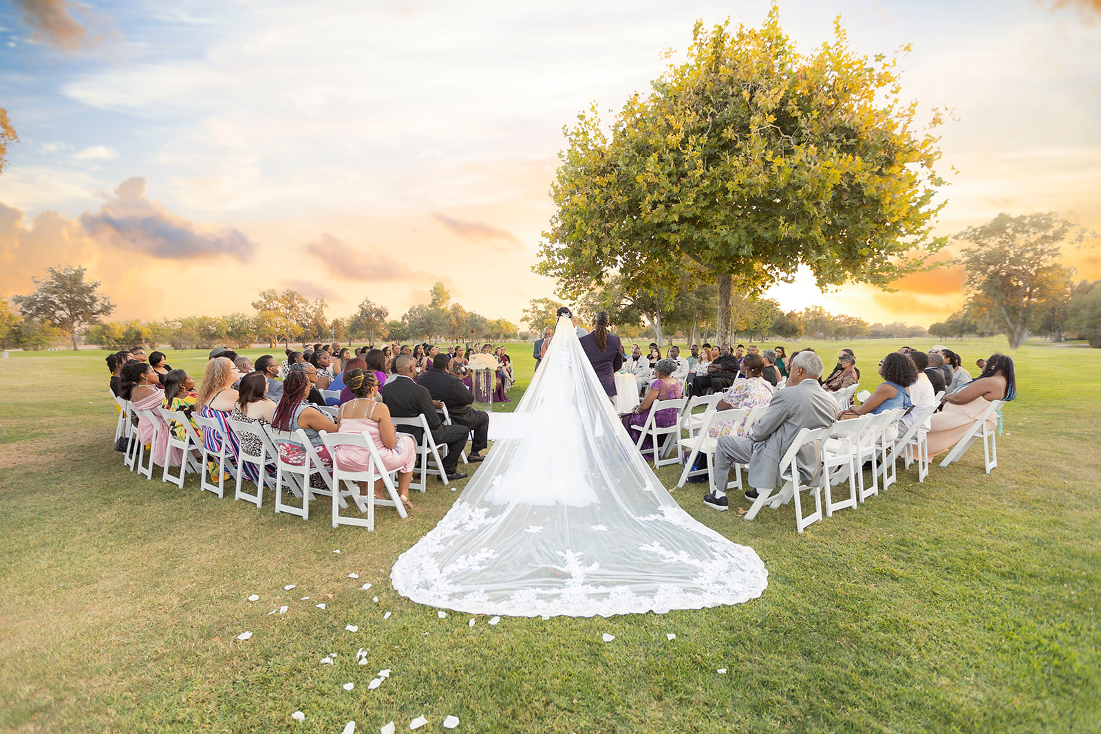 a couple who is posed for their ceremony at the pavilion at haggin oaks near the tree