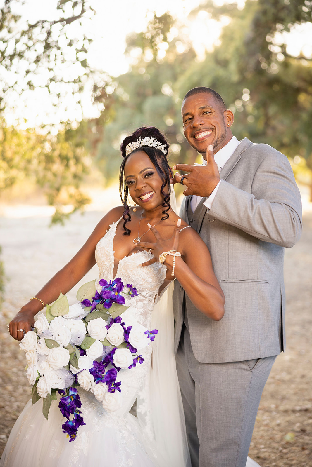 a happy couple posed for their post wedding couples portrait session at the pavilion at haggin oaks near trees