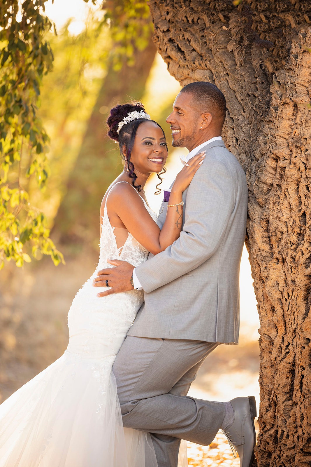 a happy couple under the tree at their post wedding couples portrait session at the pavilion at haggin oaks