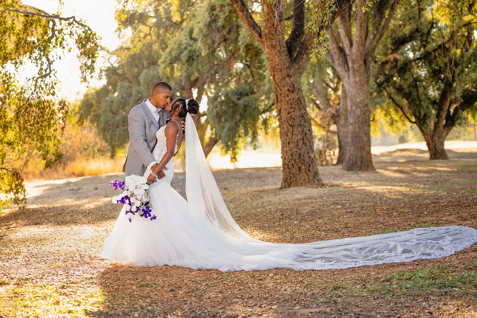 a landscape picture of the brides dress at the pavilion at haggin oaks near trees