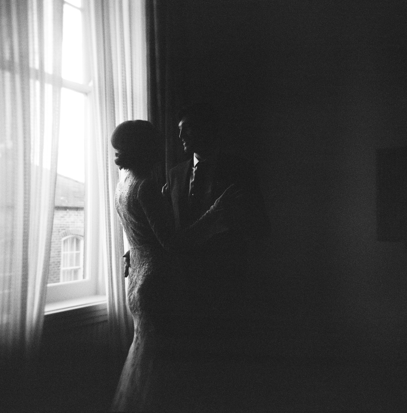 Romantic embrace of the bride and groom on Ilford Delta 3200 film