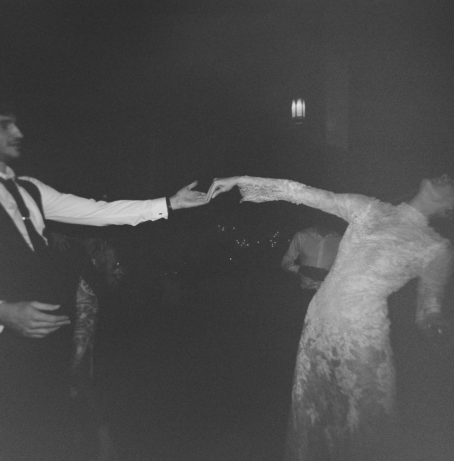 Vintage-inspired embrace on Ilford Delta 3200 film with captivating grain