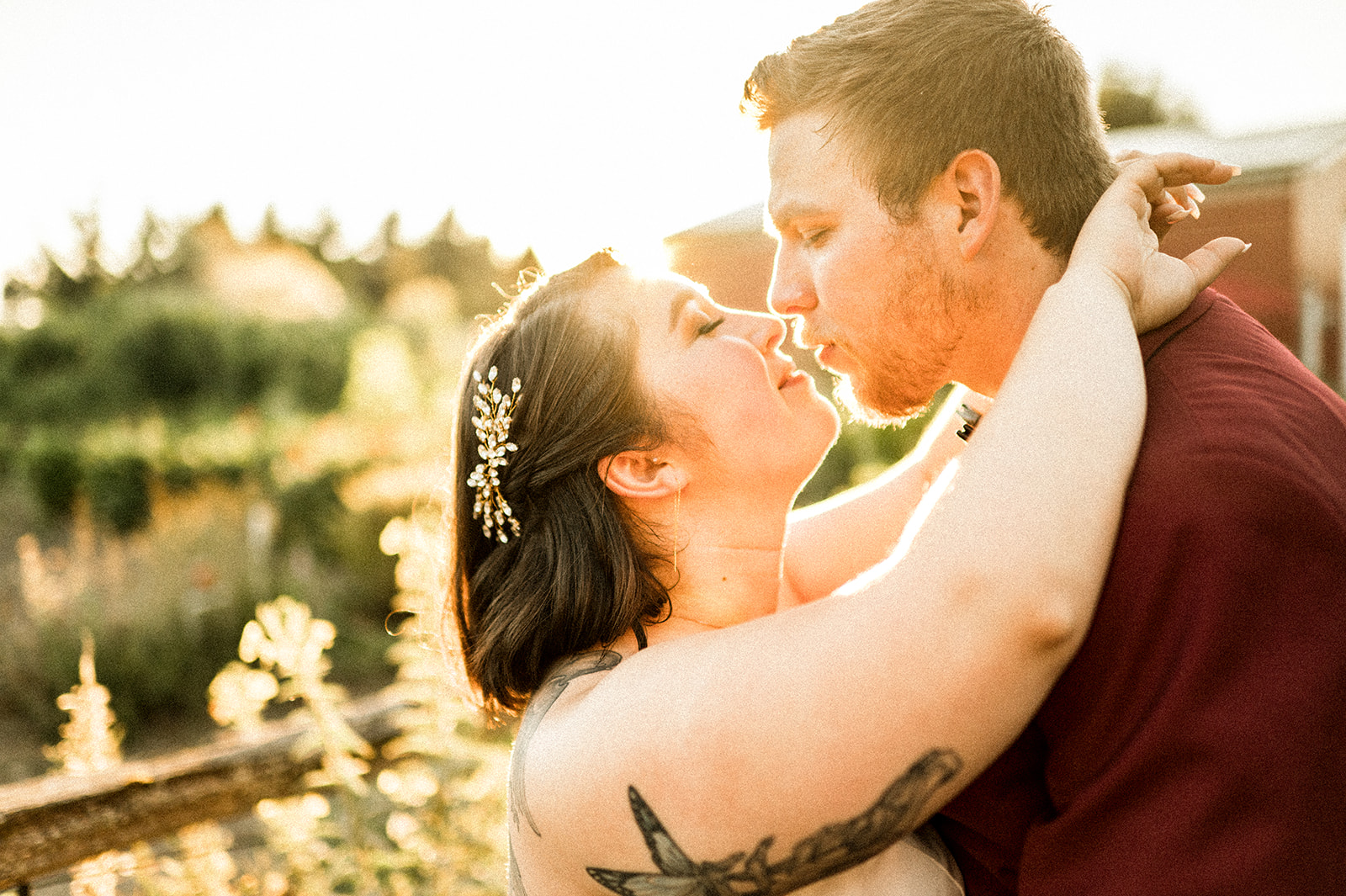 sunset portraits at lucy's garden of a couple with tattoos and groom in red suit