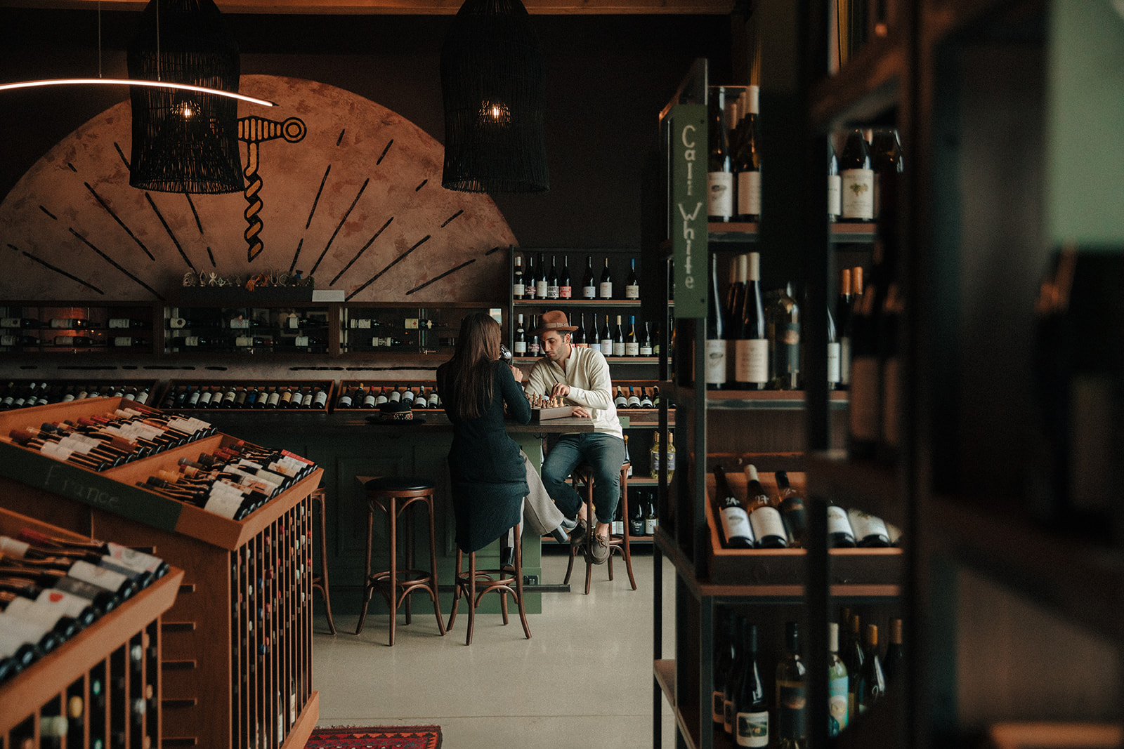 Couple playing chess in a Milwaukee wine bar