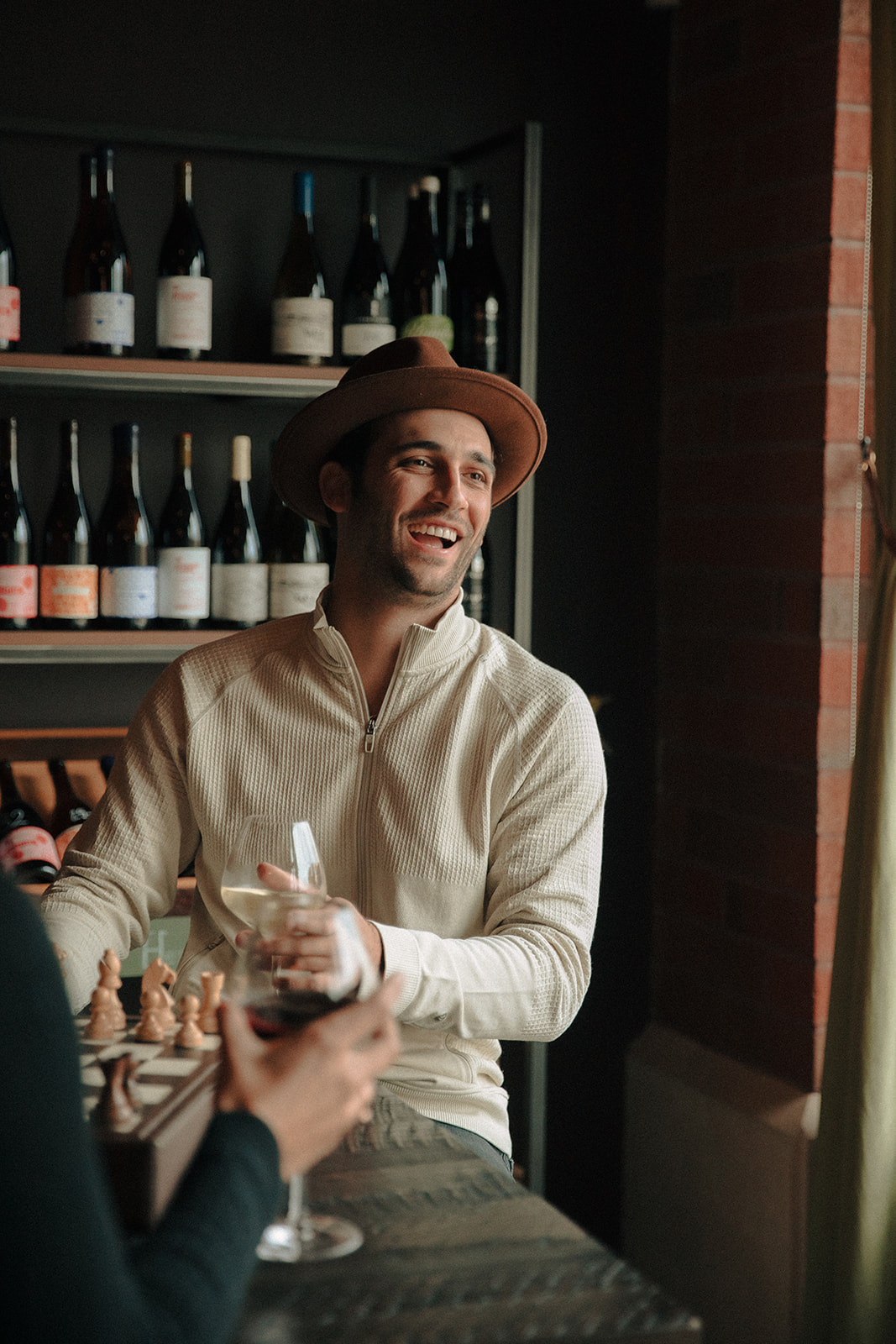 Man laughing in a wine bar