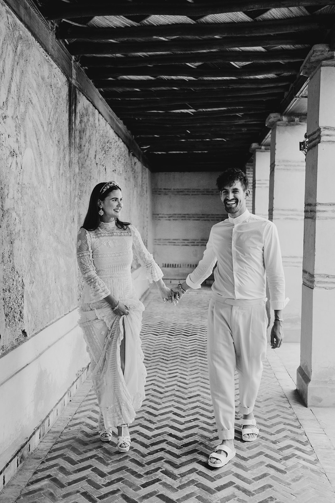 A couple who eloped in Marrakech walk through gardens of Les Deux Tours hotel in Marrakech