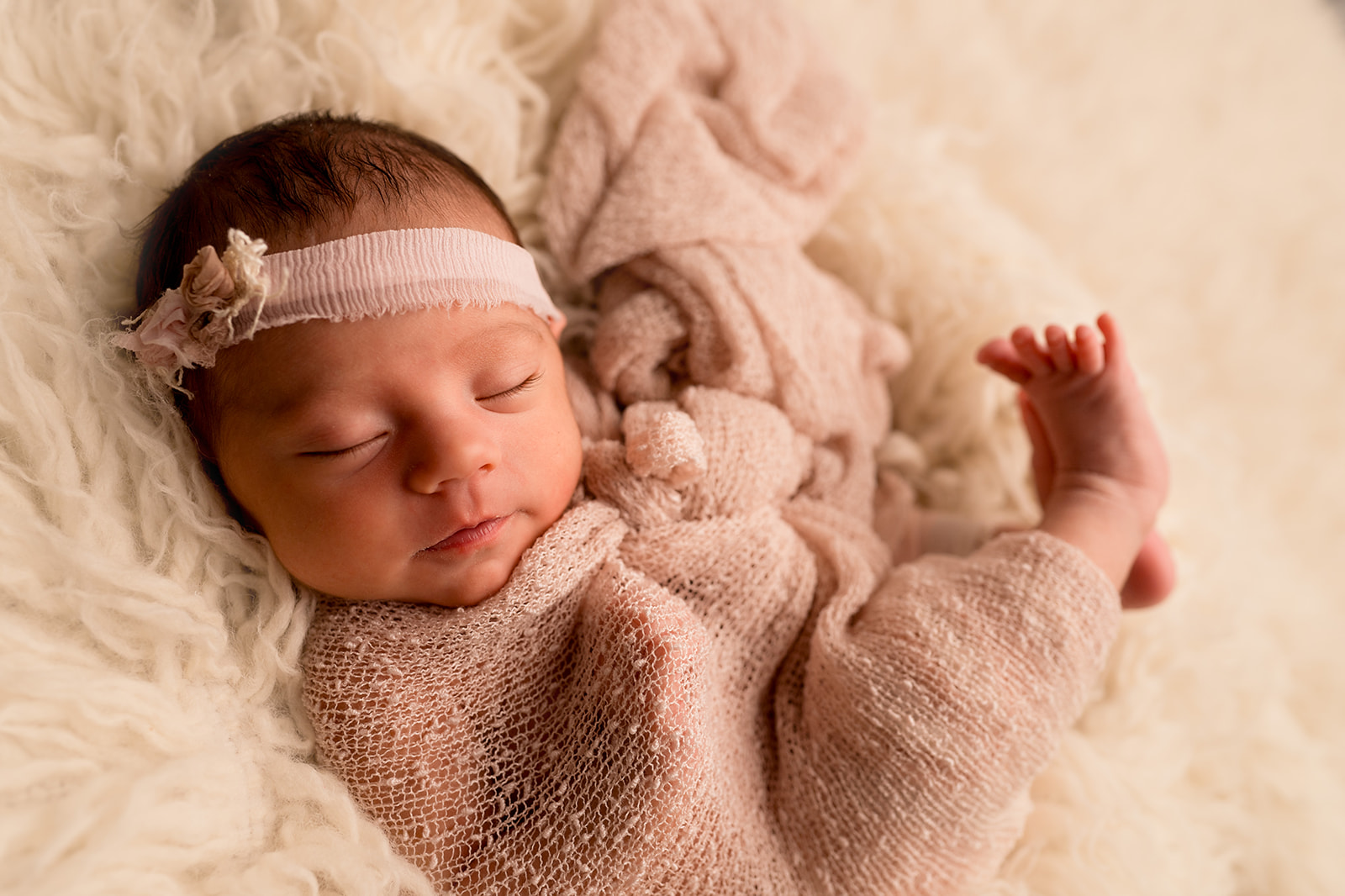 Swaddled sleeping baby posed for Loveland studio pictures