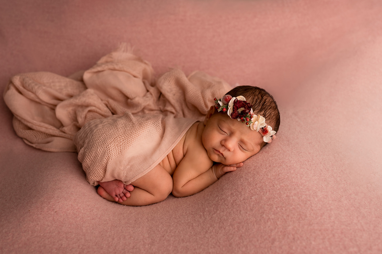 Tushy up pose of newborn baby girl all in pink in Loveland Photography studio