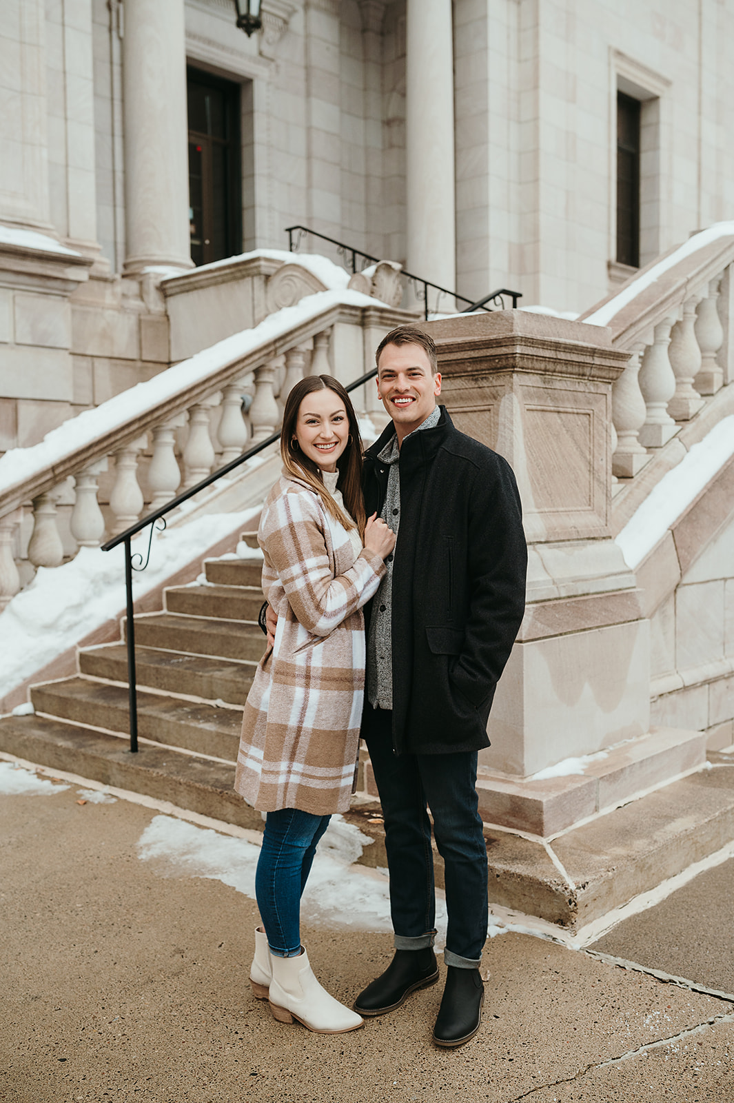 A couple who took their engagement photos in front of a historic library in downtown Saint Paul MN