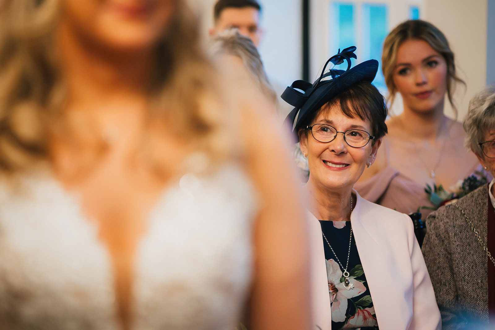 mother of the bride watches her daughter saying her vows