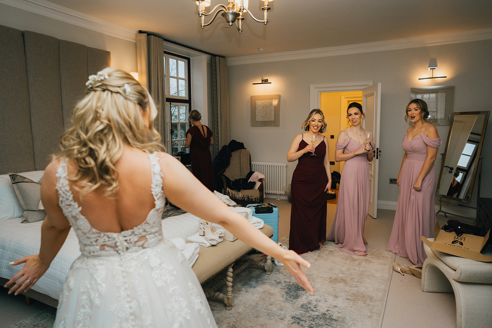 the bride reveals her wedding dress to her bridesmaids