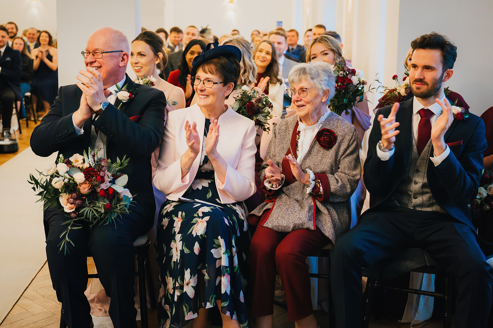 wedding guests clap as the couple are pronounced husband and wide