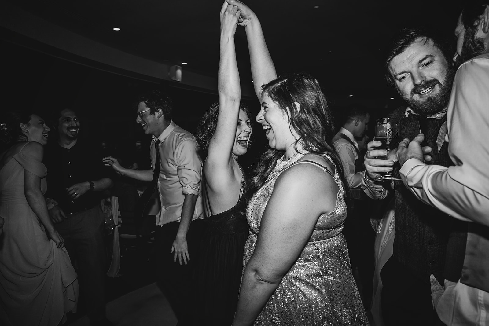 wedding guests dancing to the band in black and white