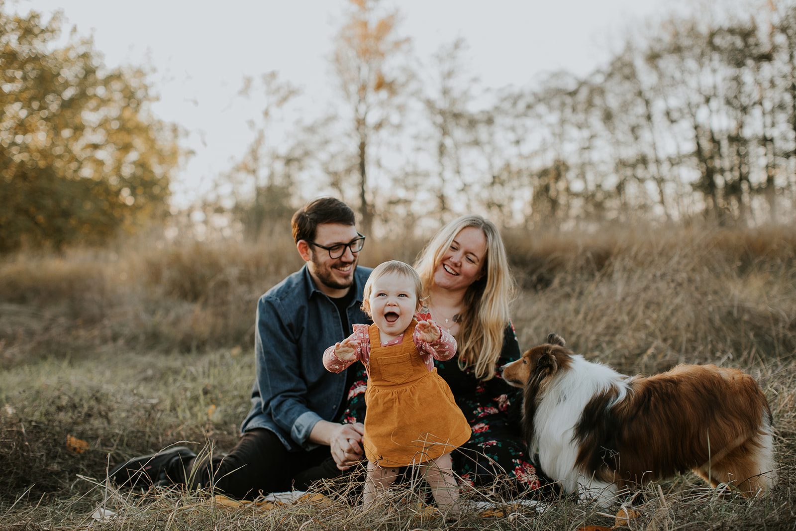 Family in a field with dog