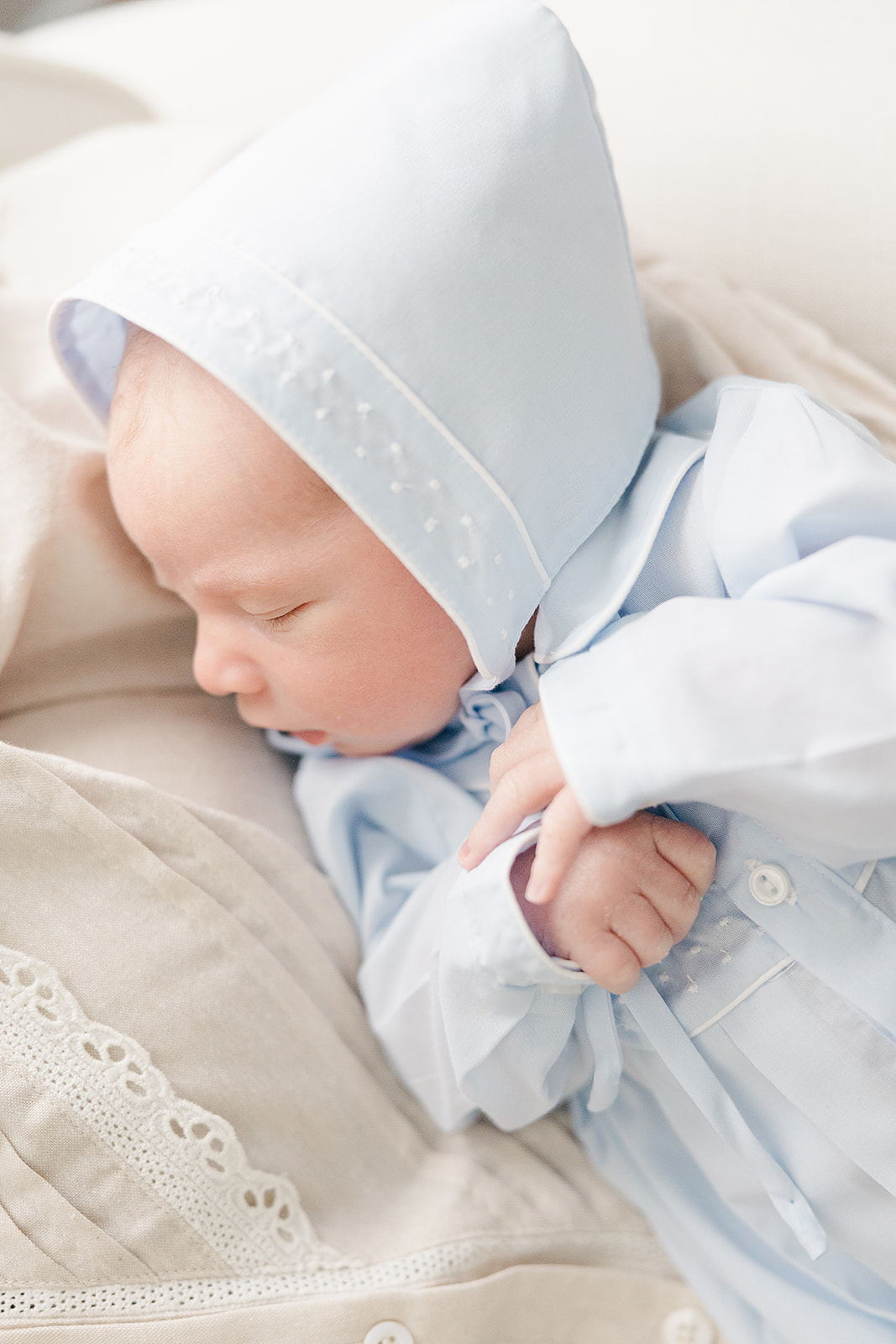 Blue and white newborn boy in bonnet