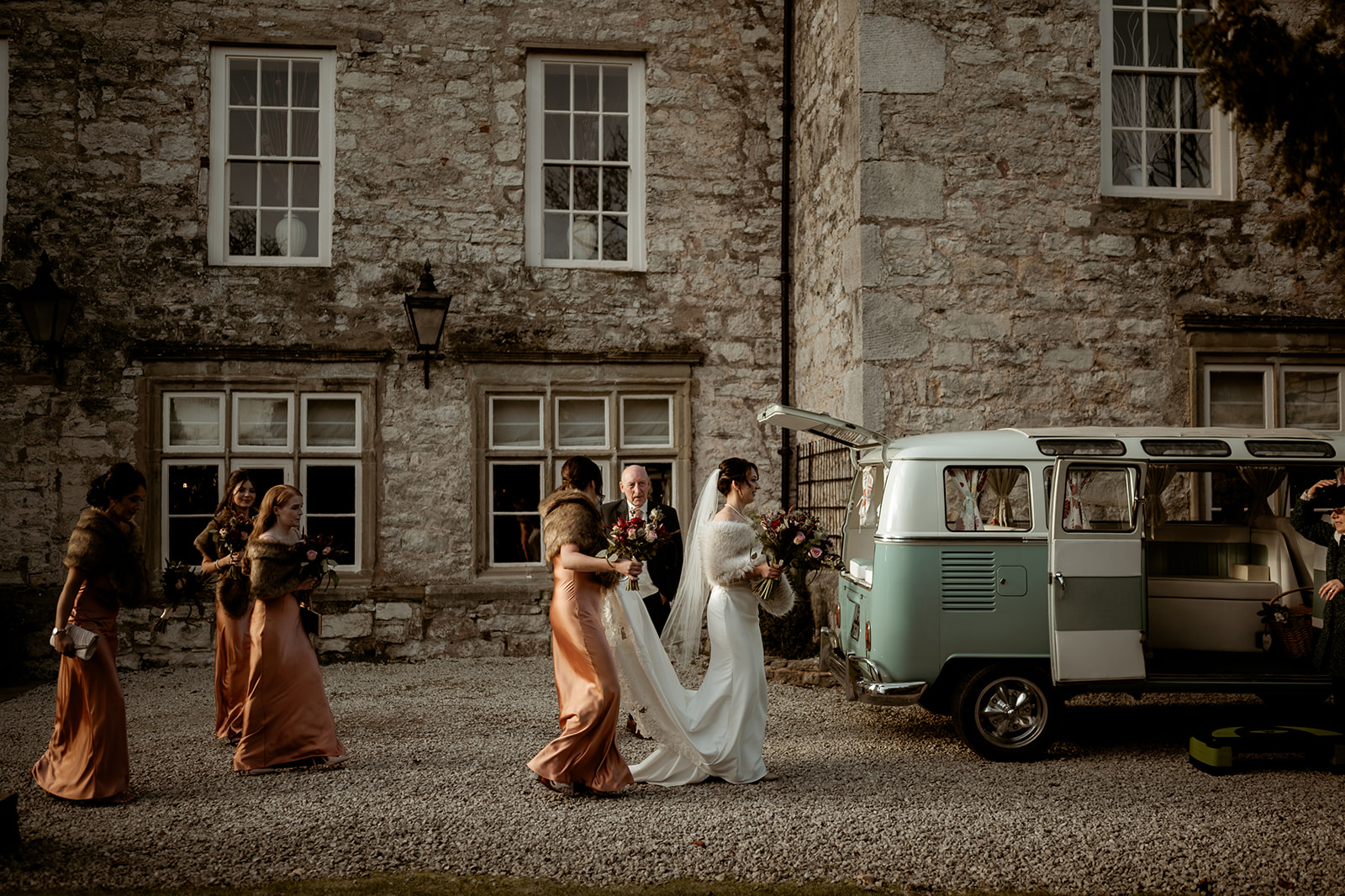 Bride and her bridal party walking towards a VW camper van at Faenol Fawr Country House Hotel.