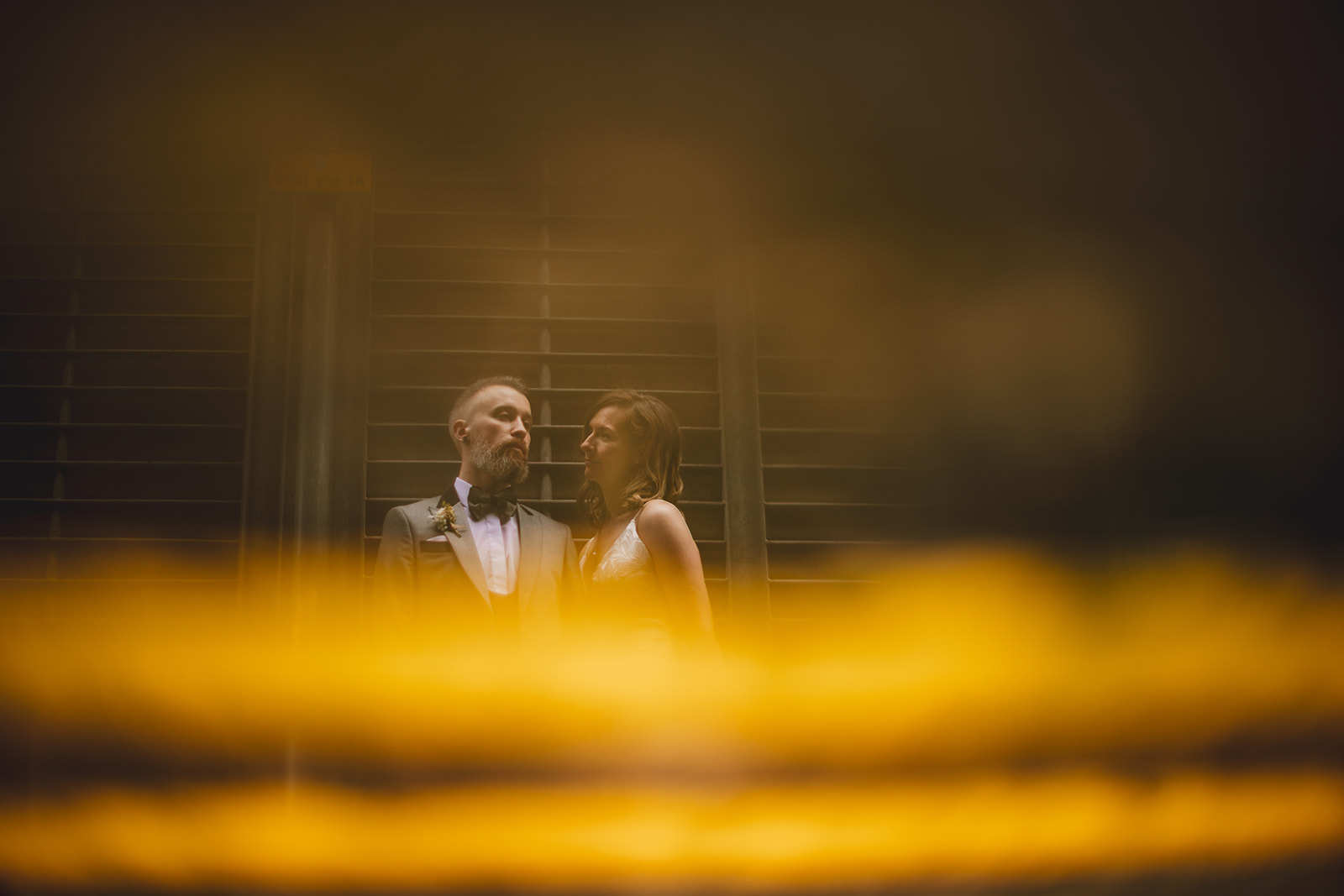 A couple in the rain in Belfast City by navyblur wedding photographer