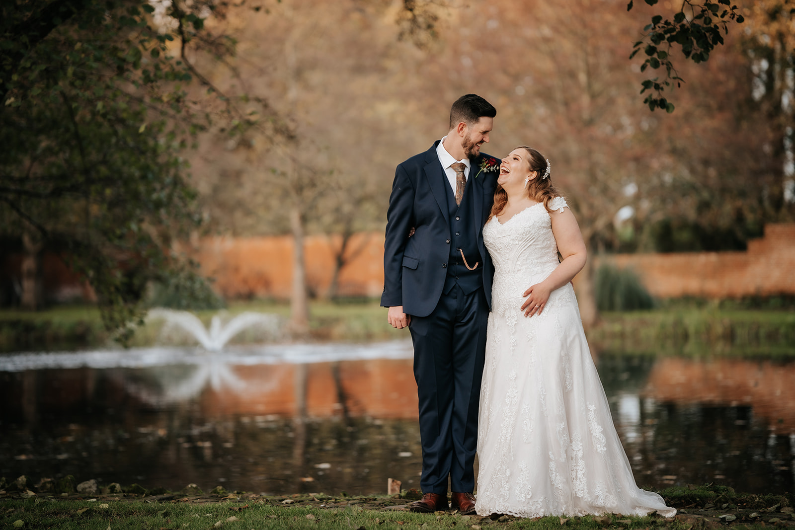 Wedding couple by the lake at Leez Priory wedding venue in Essex