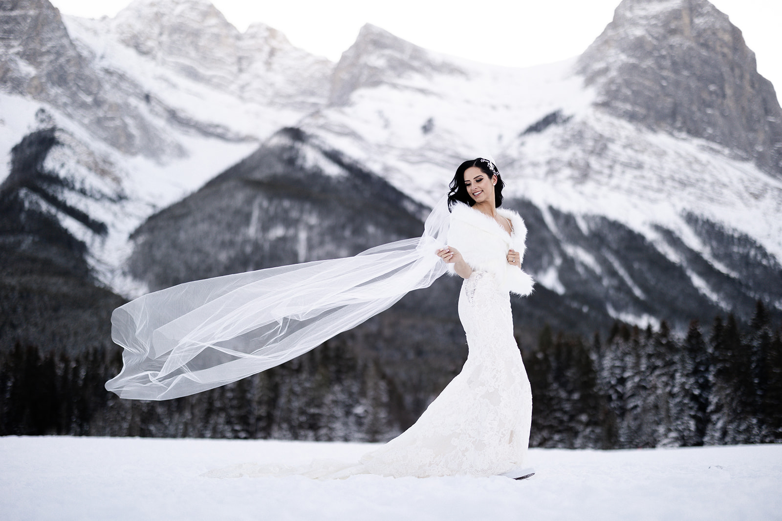 Bride in the cold. Canmore winter Wedding shot at Cornerstone by Calgary Wedding photographers Tkshotz Photography 