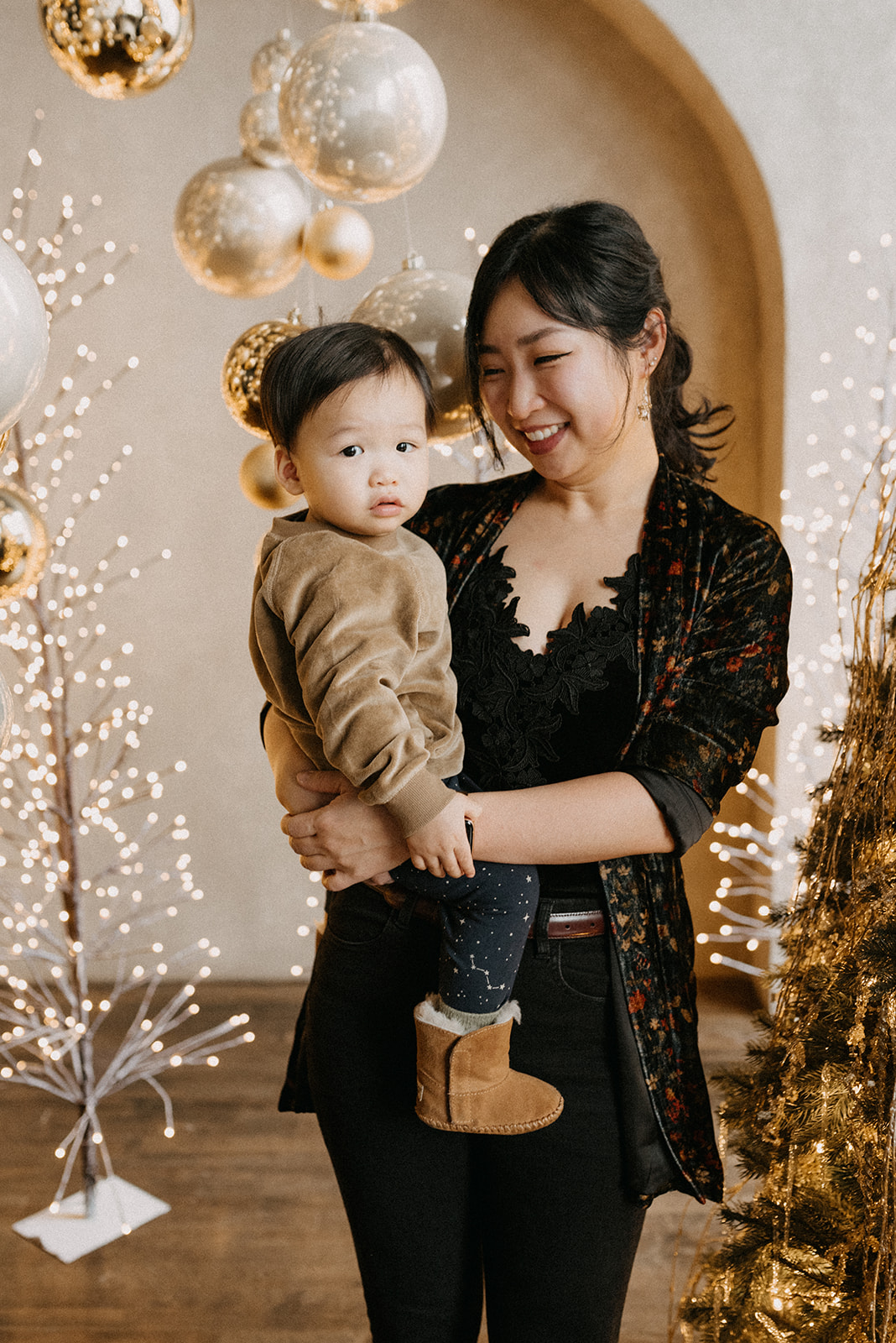 Mommy and son Xmas photo in a gold shiny holiday set up in Toronto