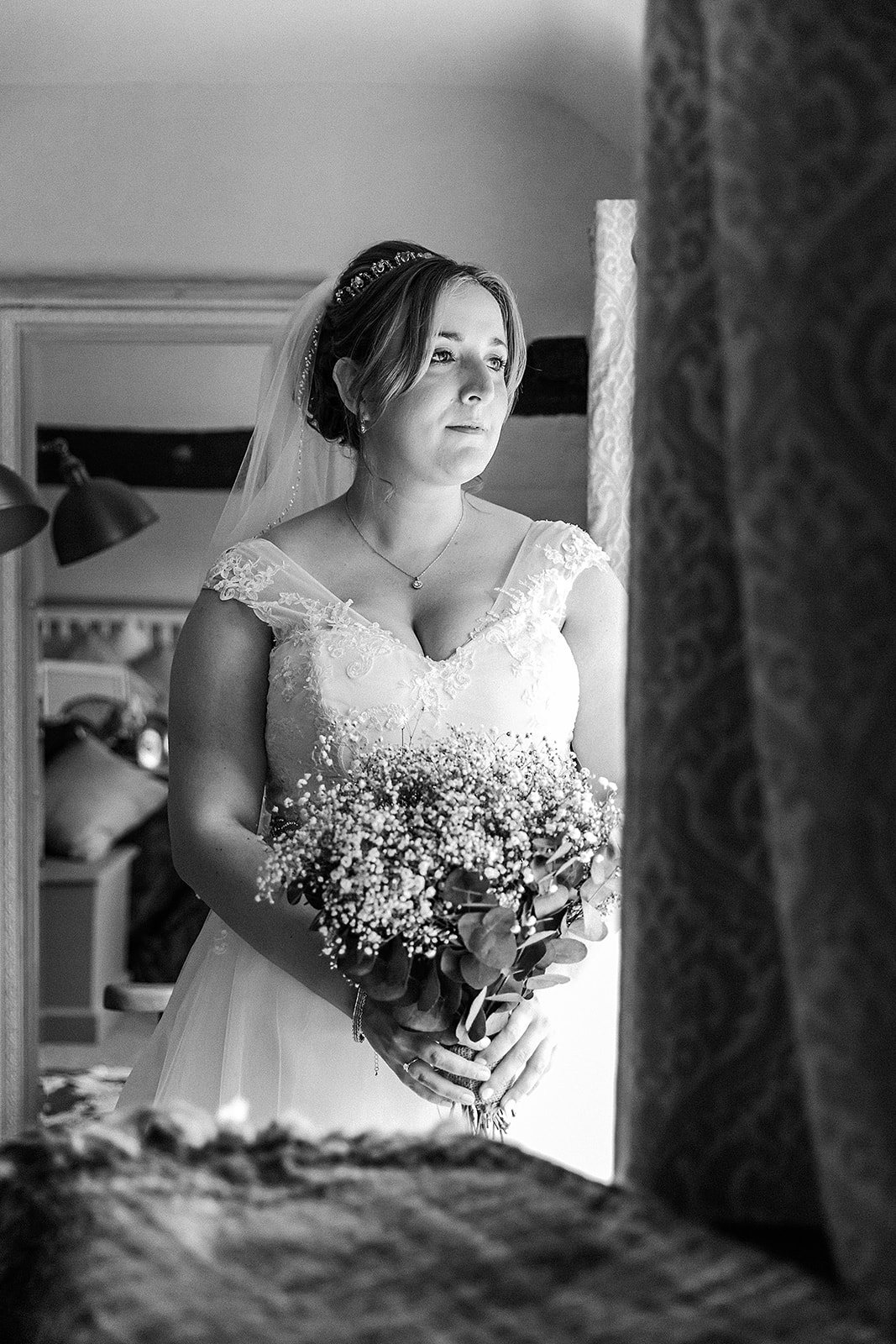 Bride looking out the window of her cottage in dagnall in her wedding dress Photo by Perfect Memories Photography