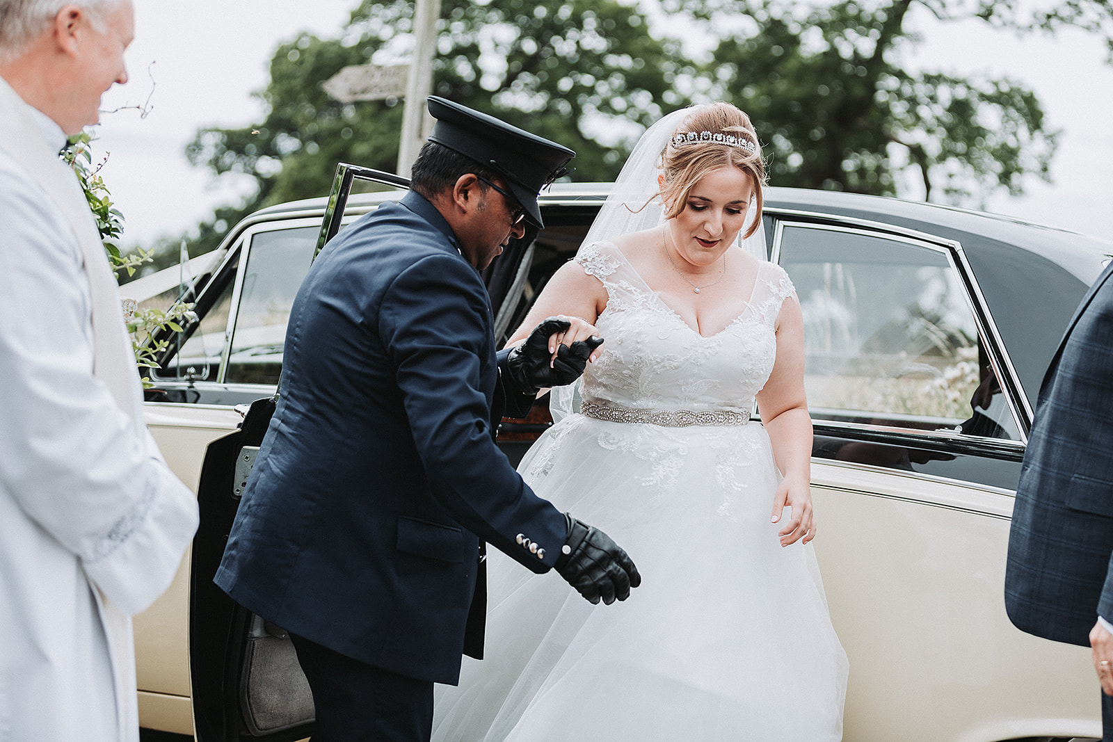 Bride getting out of her wedding car in her dress. Wedding Photo by Perfect Memories Photography