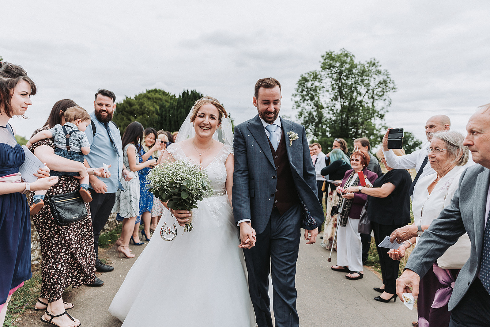Bride and groom outside little gaddesden church confetti throw Wedding Photo by Perfect Memories Photography