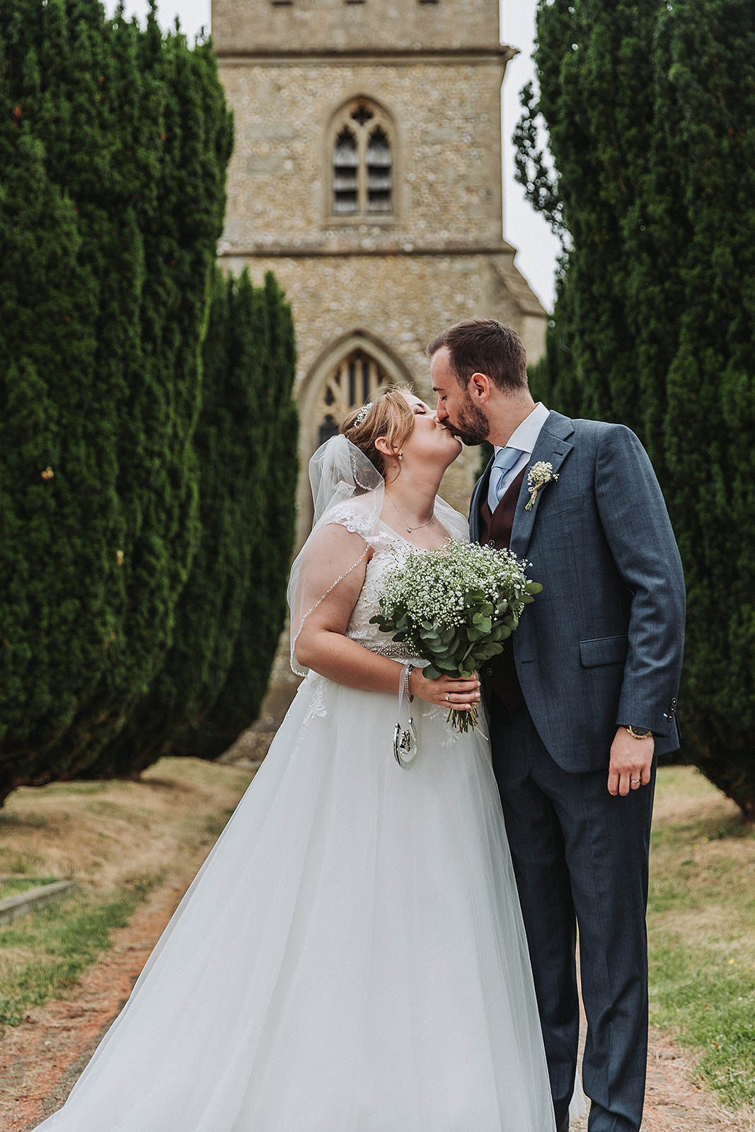 Bride and groom outside Little Gaddesden Church, Hertfordshire Wedding Photo by Perfect Memories Photography