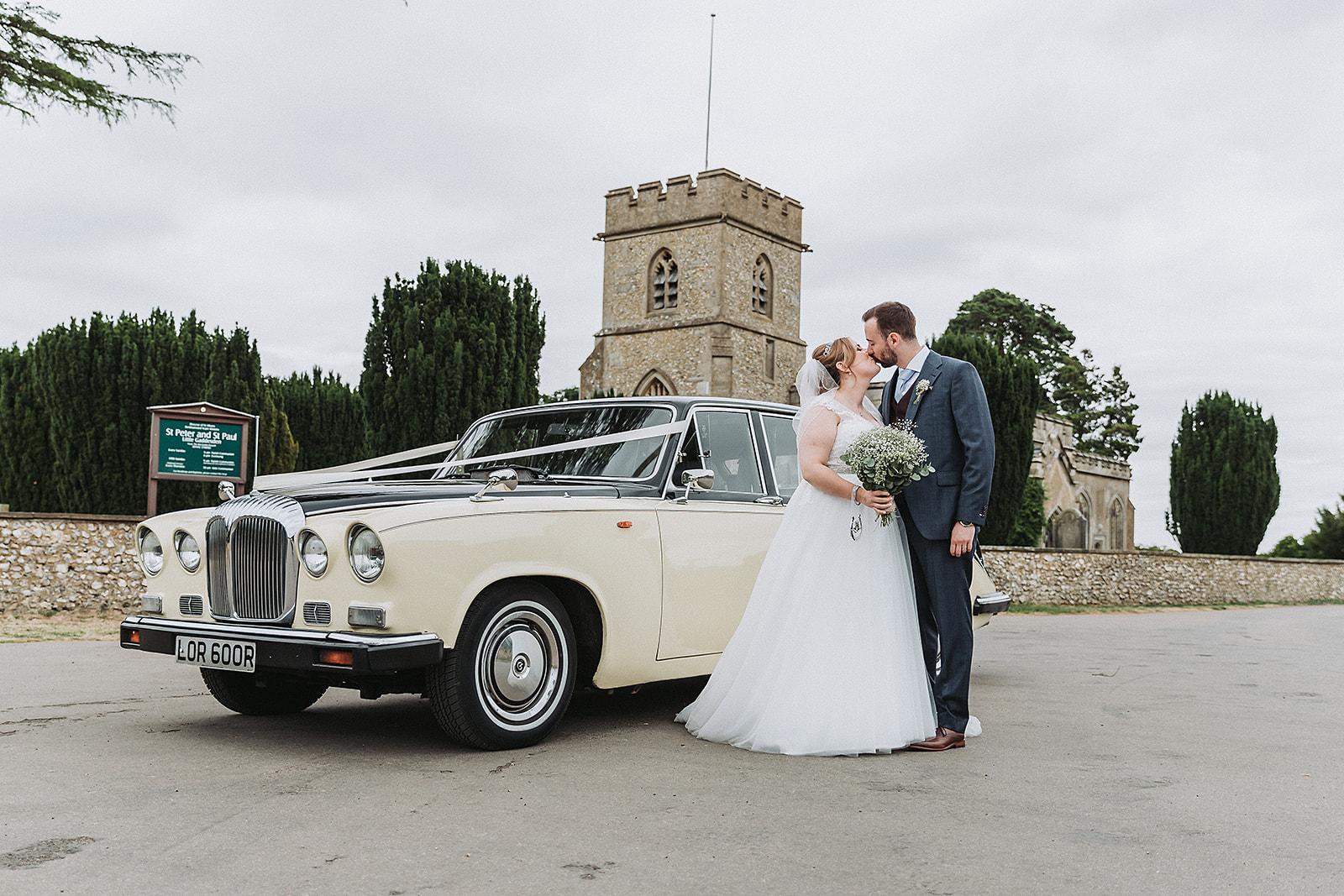Bride and groom with the wedding car from Lord Cars outside little gaddesden church wedding photo