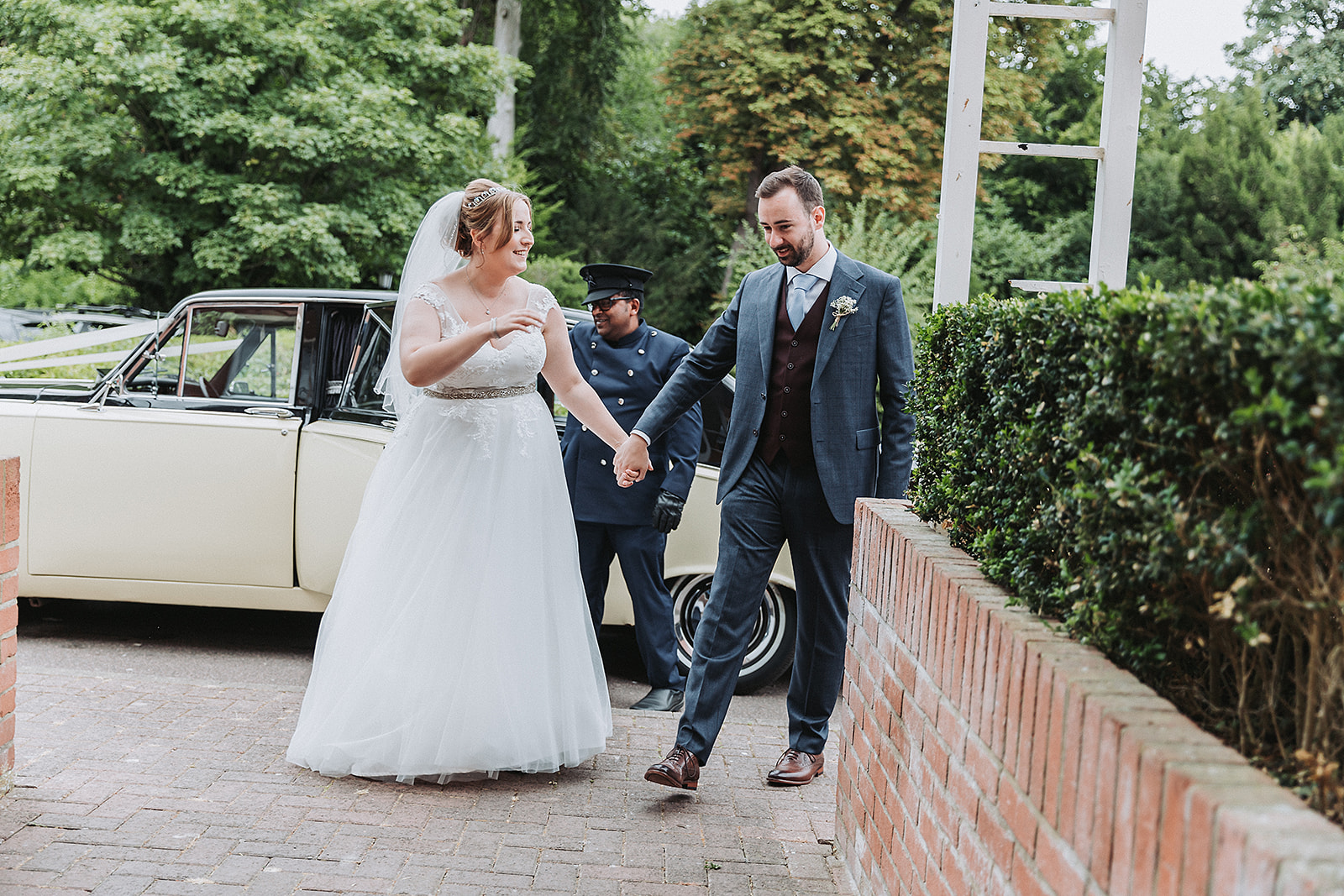 Bride and groom arriving at their reception at Pendley Manor Tring. Wedding Photo by Perfect Memories Photography