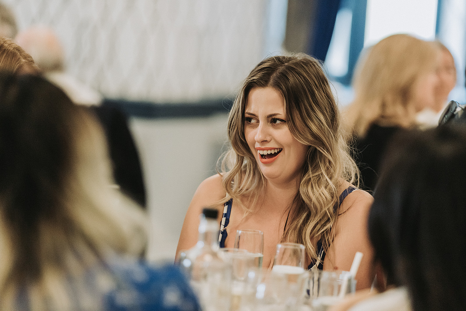Wedding guest laughing at the reception at Pendley Manor, Tring. Wedding Photo by Perfect Memories Photography.
