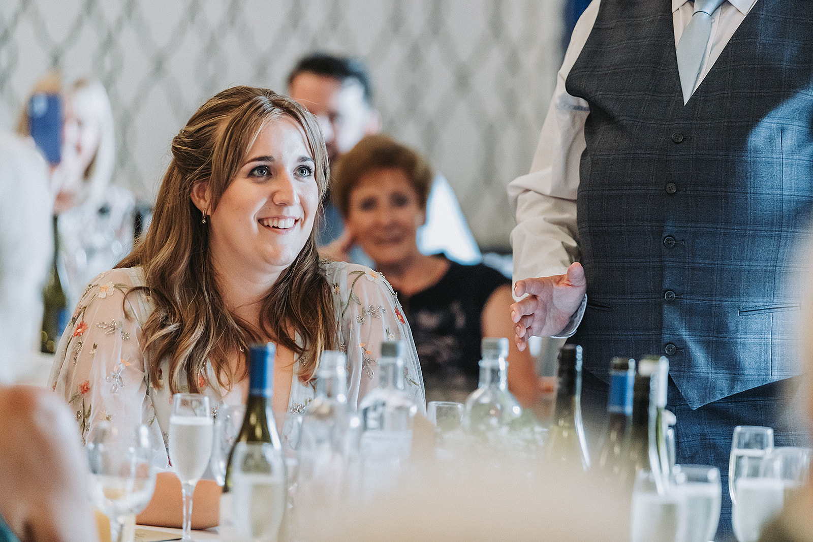 Wedding guest smiling at Pendley Manor, Tring. Wedding Photo by Perfect Memories Photography.